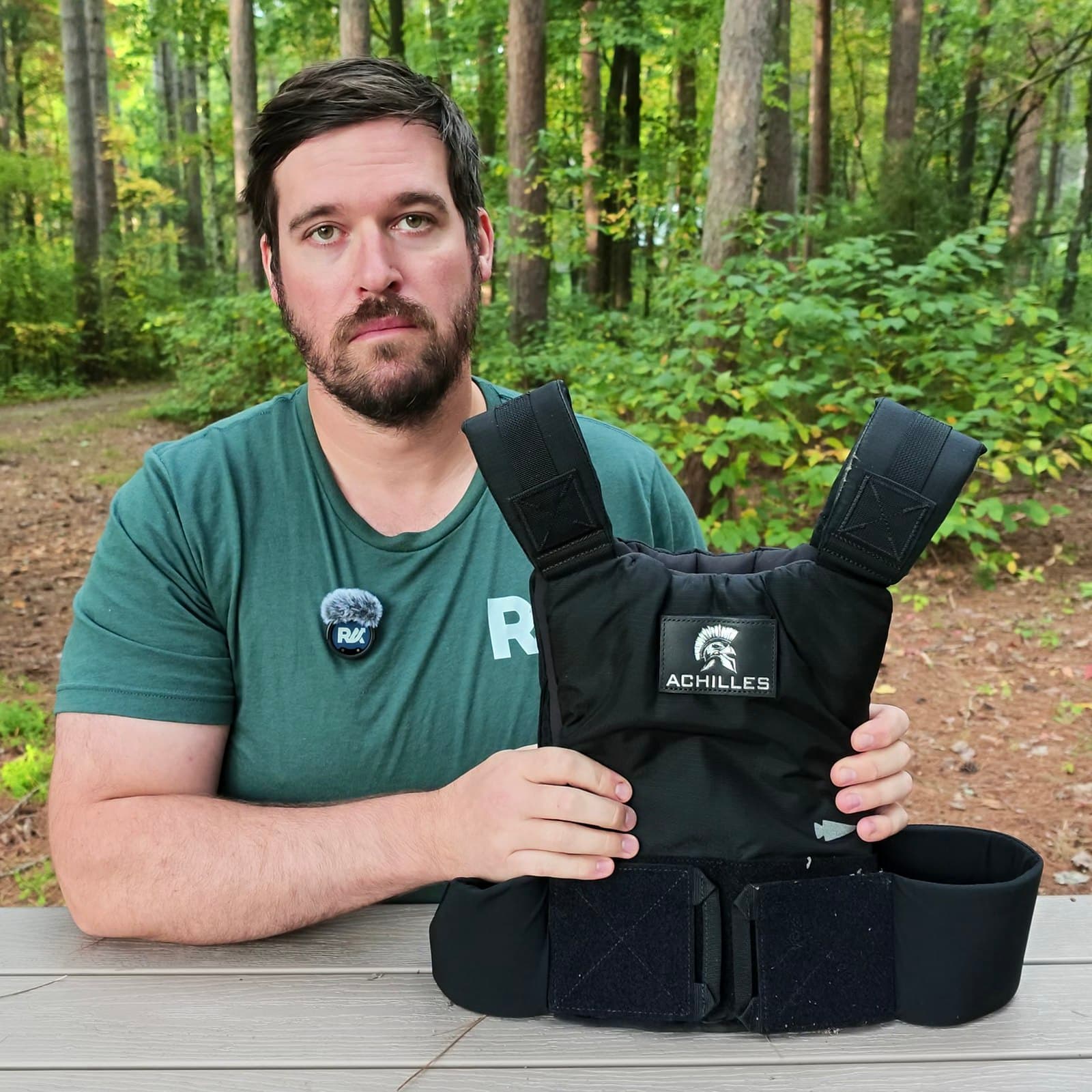 Joel Kelly holding his black 30 lb GORUCK Achilles weighted vest