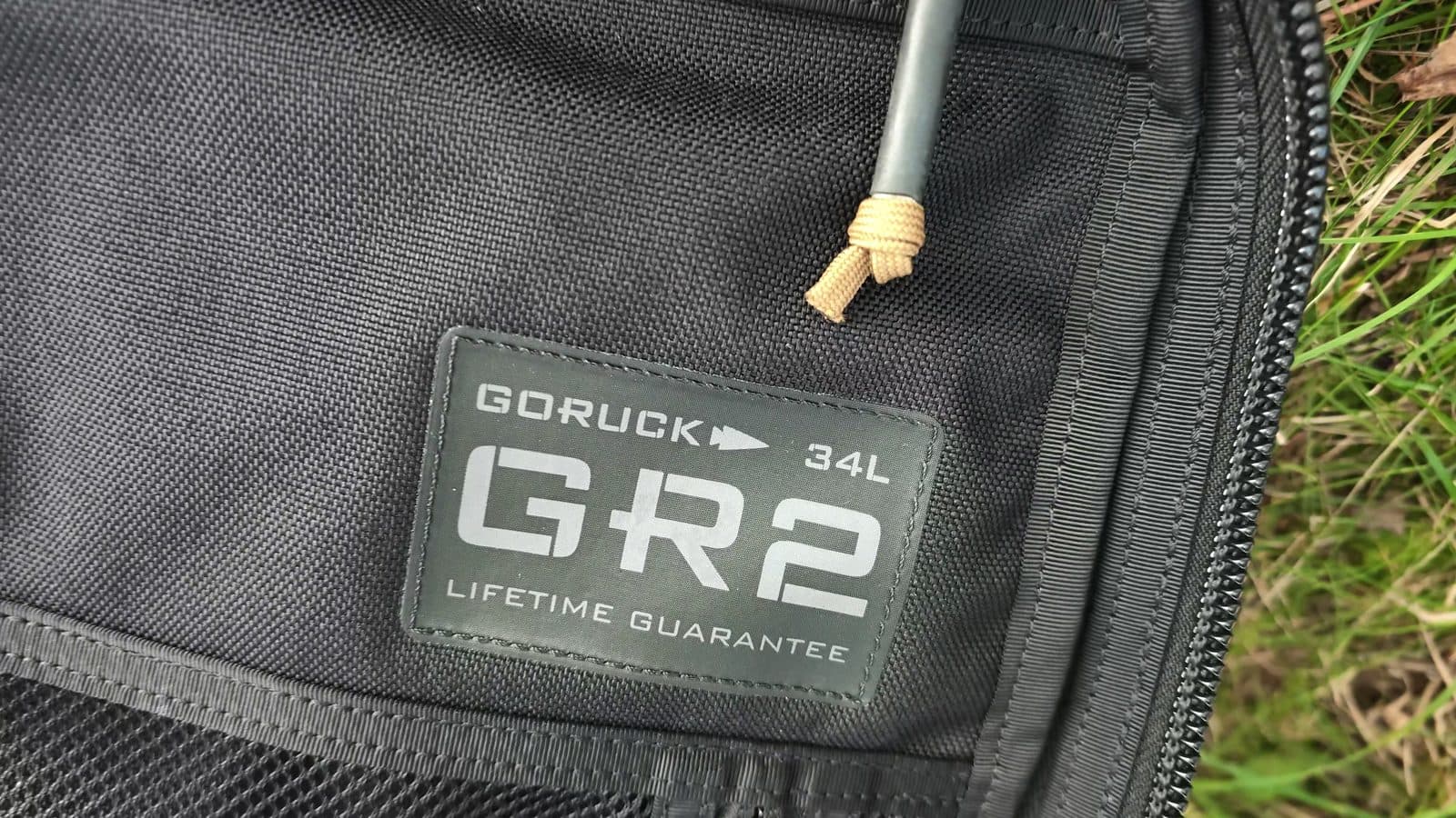 The GR2 34L lifetime guarantee label inside the bag, next to a cord zipper pull