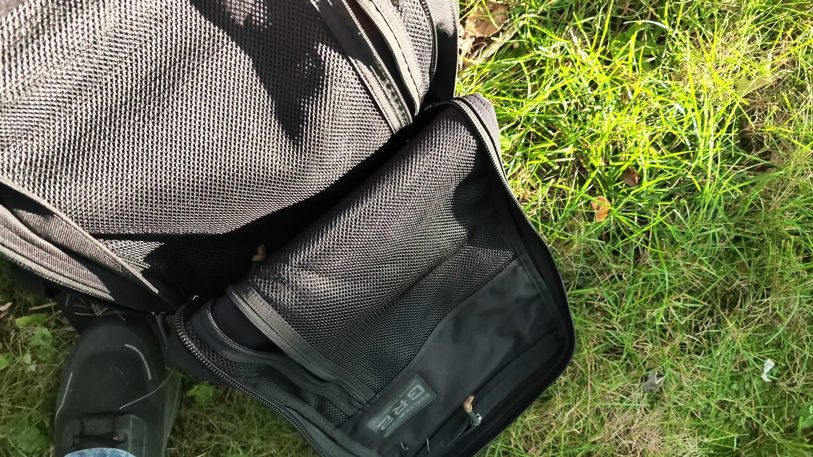 The GR2's front compartment unzipped beside the main bag