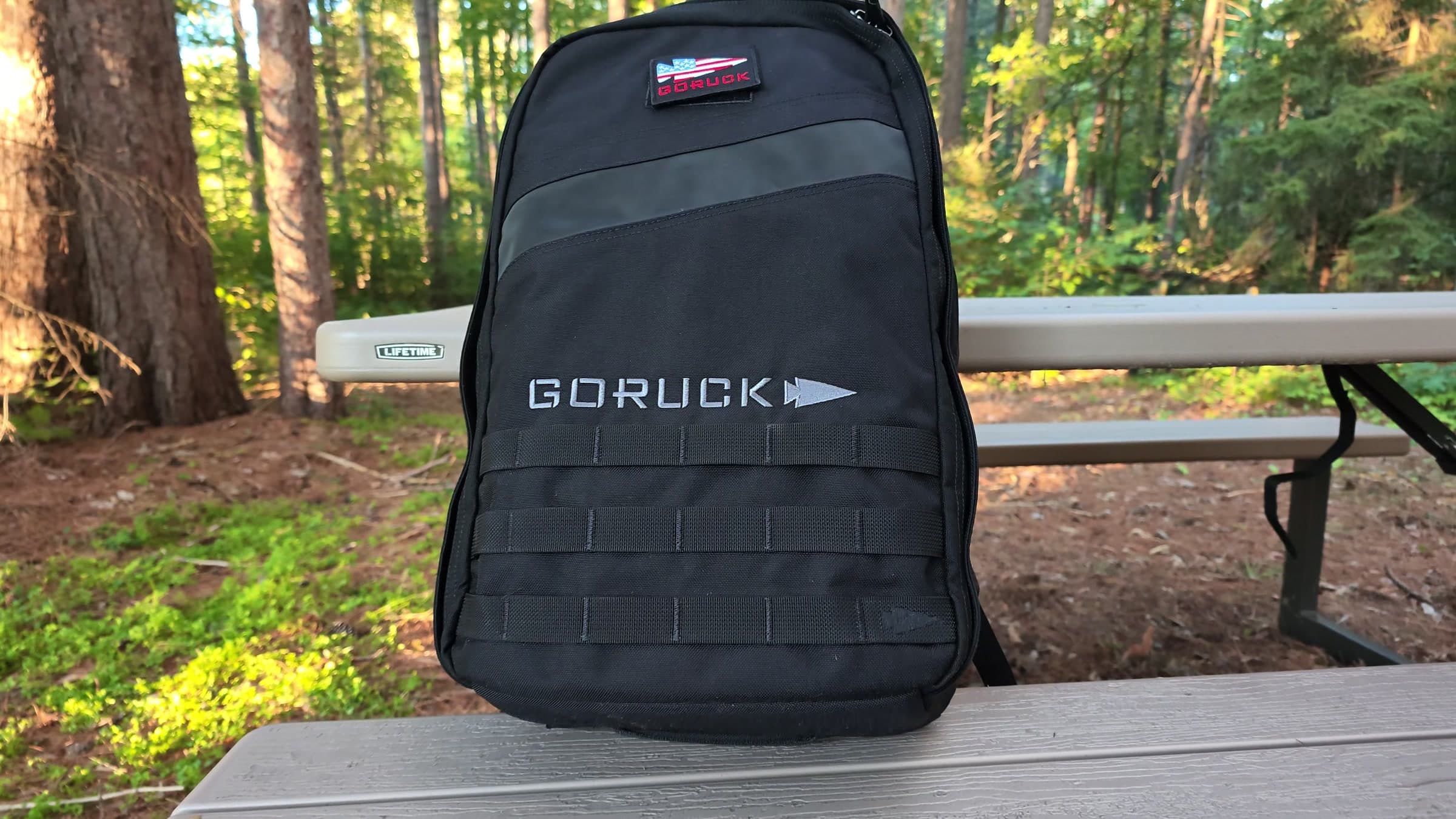 The 25L Rucker 5.0 upright on a picnic table, flag patch and GORUCK wordmark visible