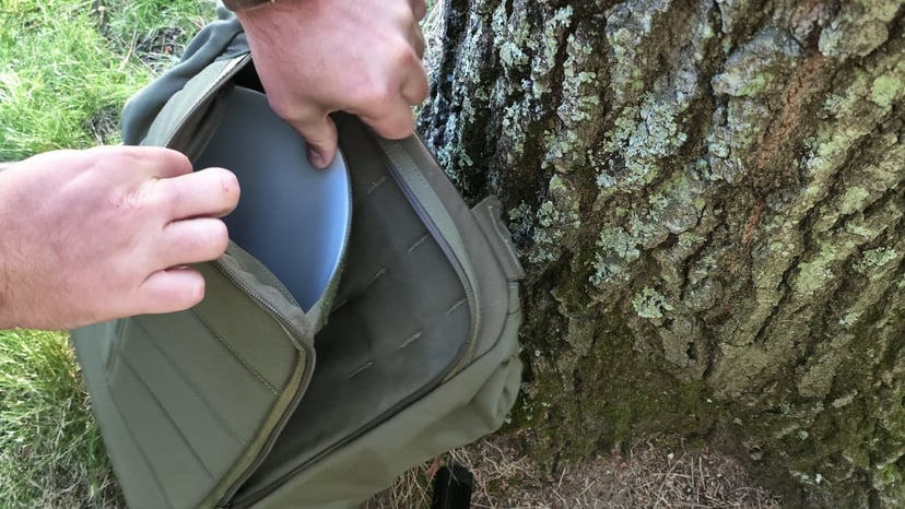 Sliding the GR1's removable frame sheet out of its padded compartment against the back