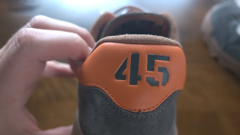 The orange leather heel tab on the Mackall 45 with 45 cut into it