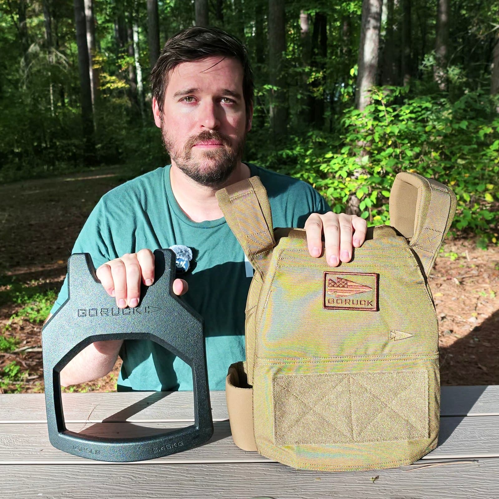Joel Kelly holding his L/XL Coyote Brown GORUCK Rucking Weight Vest