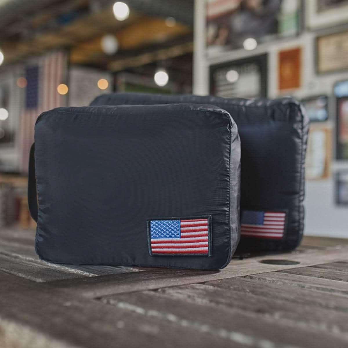 Black GORUCK packing cubes on a wooden table